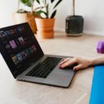 faceless woman using laptop during sport exercising